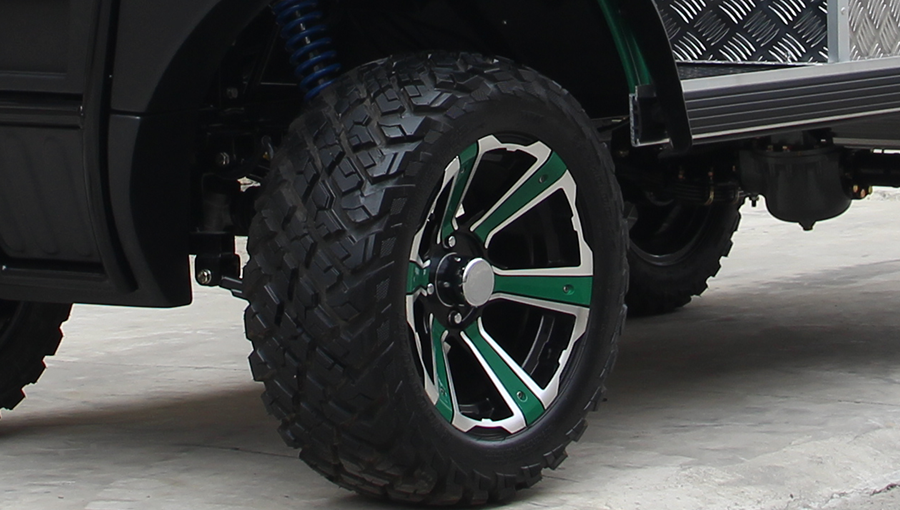 Close-up of Tara golf cart tire with deep off-road tread pattern, designed for superior traction on dirt and grass
